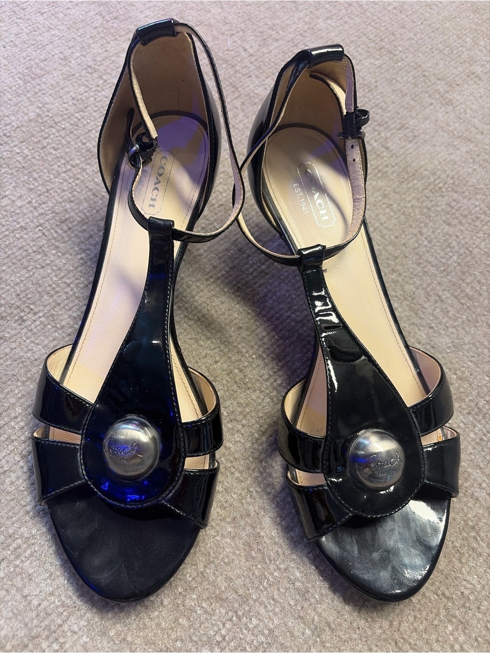Coach Black Patent Leather T-Strap Sandals with Silver Medallion Accent